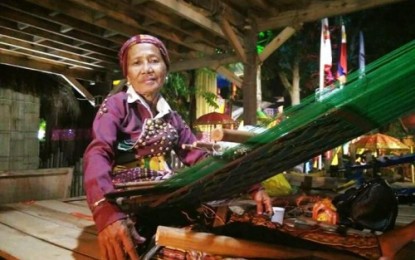 <p>TREASURE. Yakan weaver Ambalang Ausalin, 75, regarded as a national living treasure, is seen here weaving through the Yakan ‘tennun’ or tapestry-weaving tradition. She is featured as one of two national living artists, with Yakan musician Uwang Adhas, at the Basilan village of the Autonomous Region in Muslim Mindanao Villages Expo inside Shariff Kabunsuan Complex in Cotabato City. (Photo by BPI-ARMM)</p>